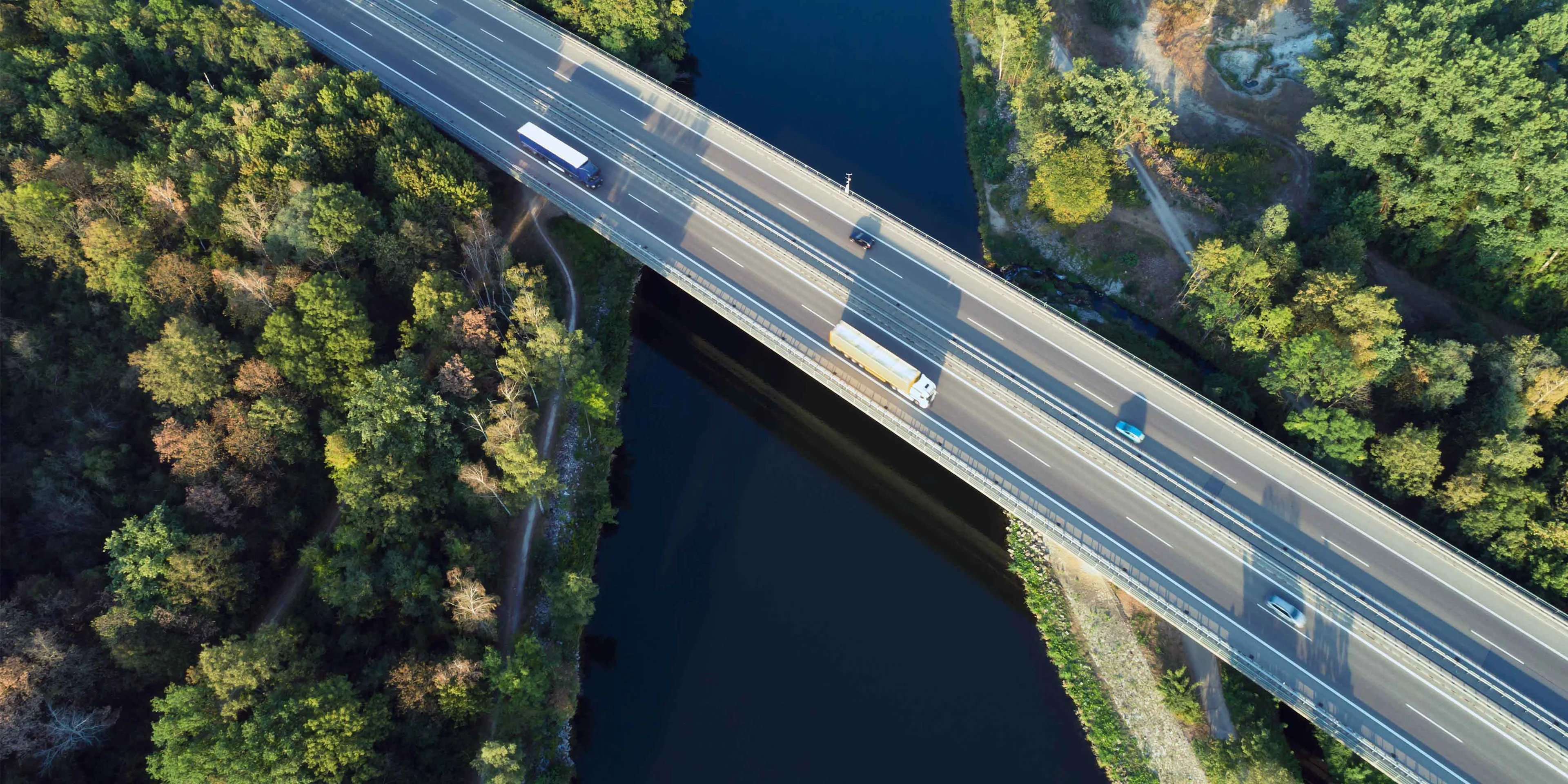 Transport trucks on an idyllic bridge