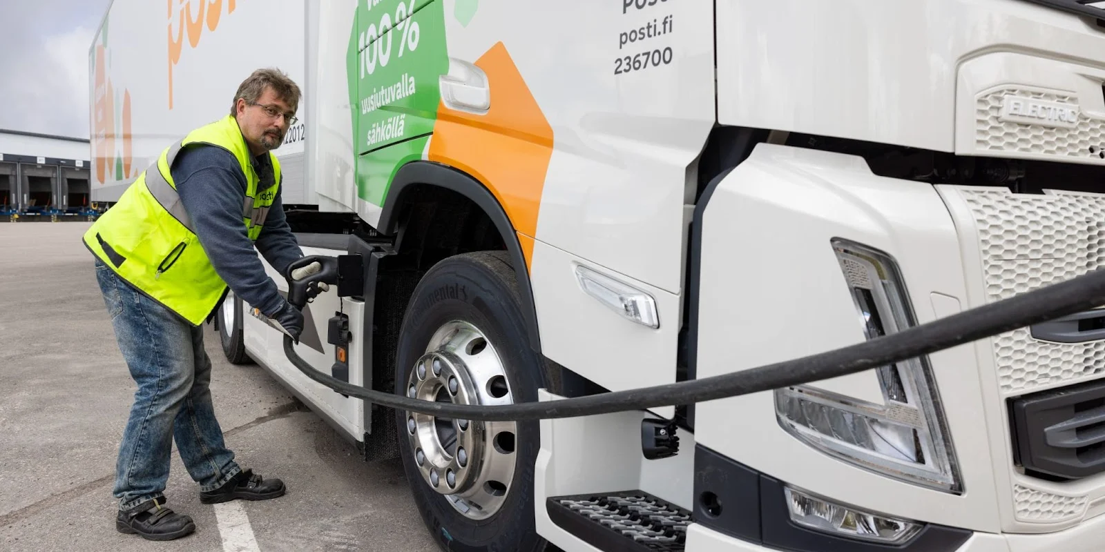 A man fueling up a mail truck