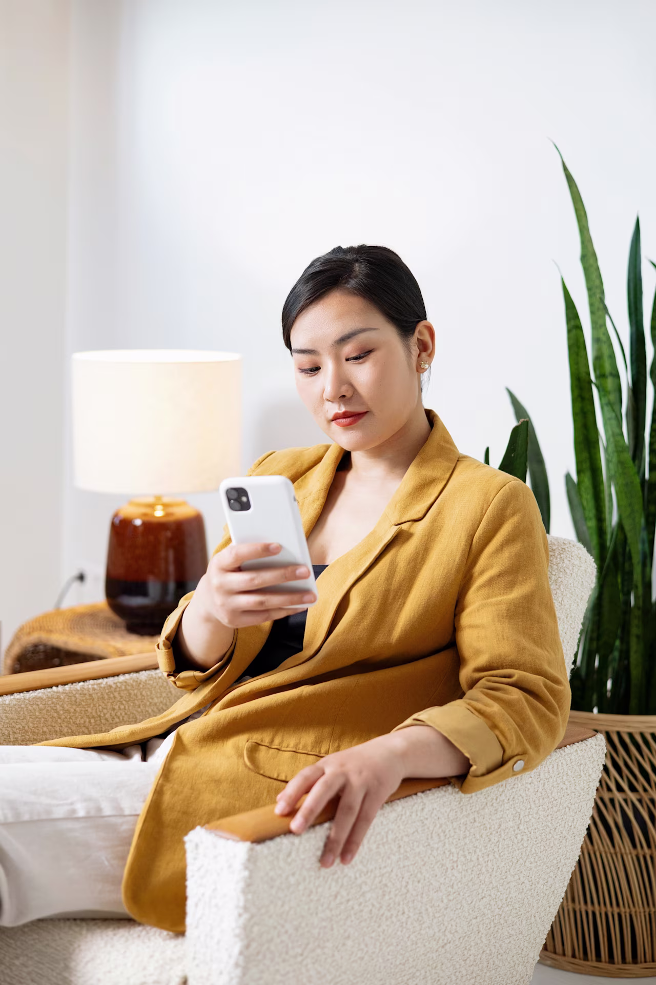 [visual] woman in yellow blazer using smartphone