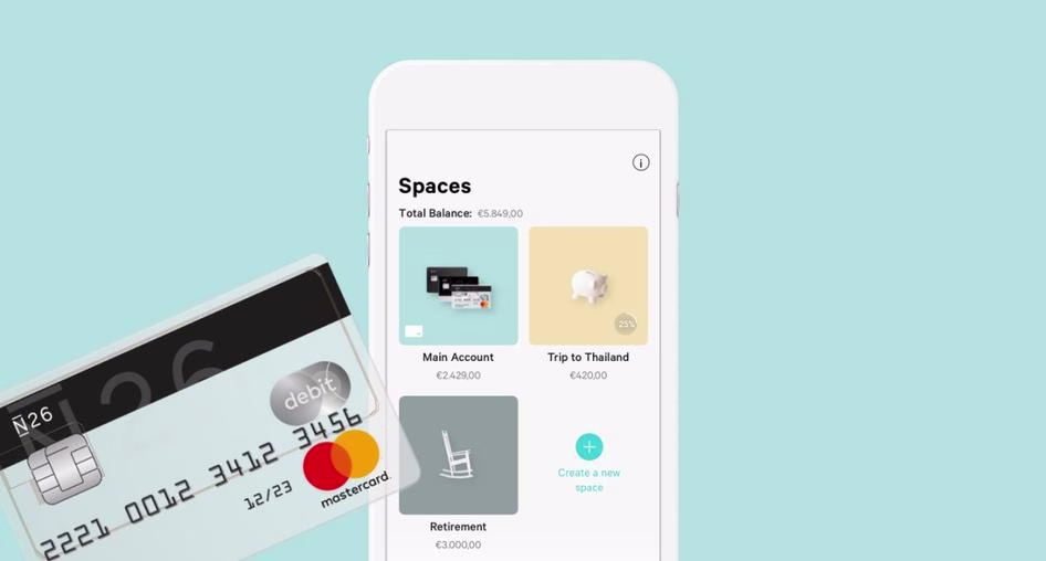 [Visual] Image of N26 bank card and phone showing UX design of customizable saving spaces on the app