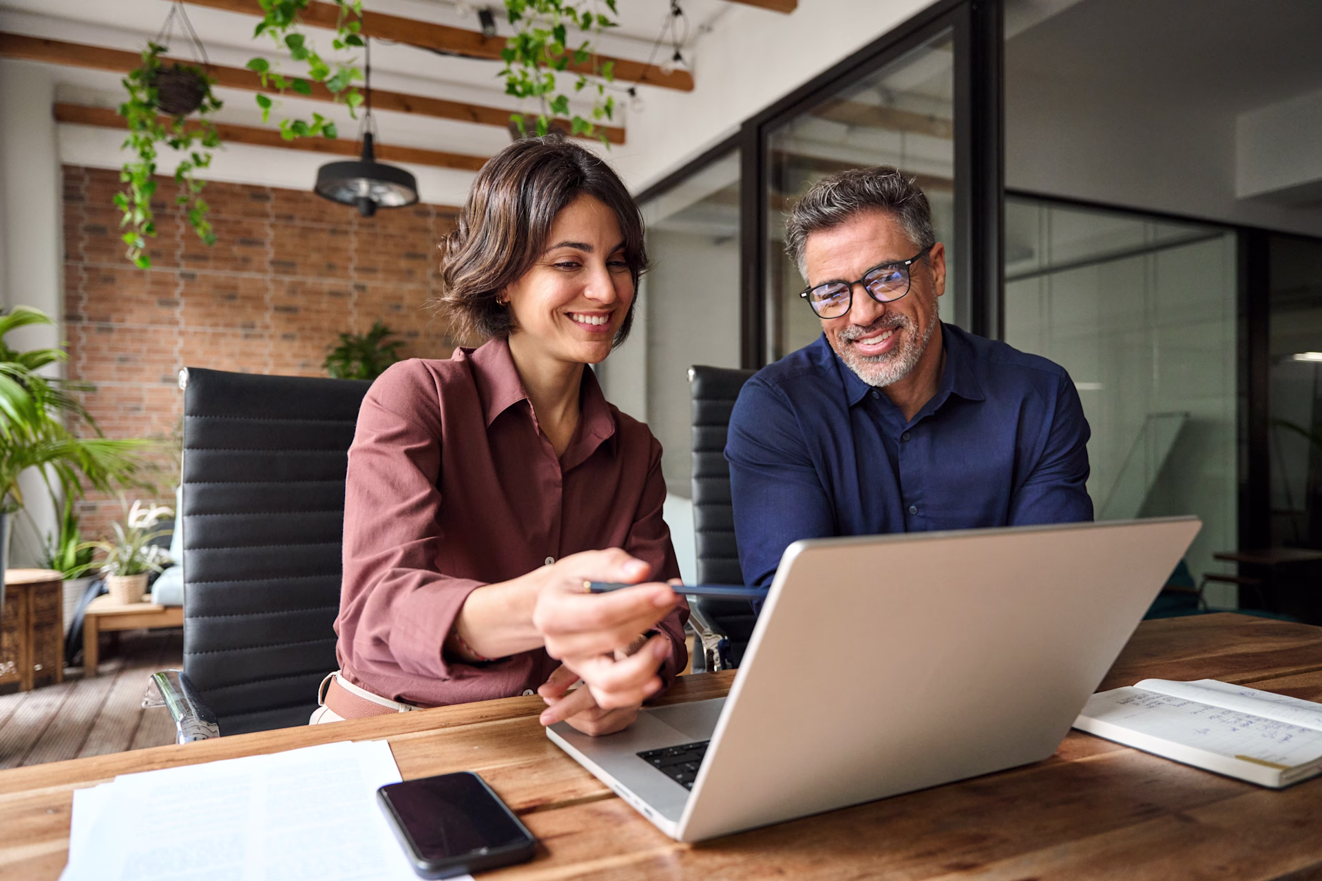 [visual] man and woman in front of a laptop