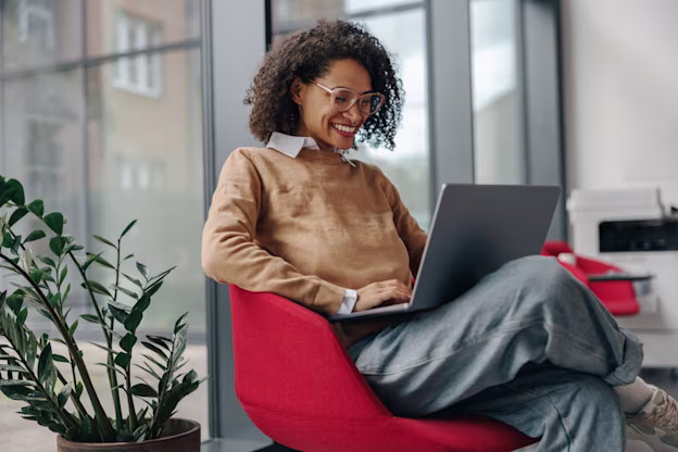 [visual] woman using laptop in modern office workspace