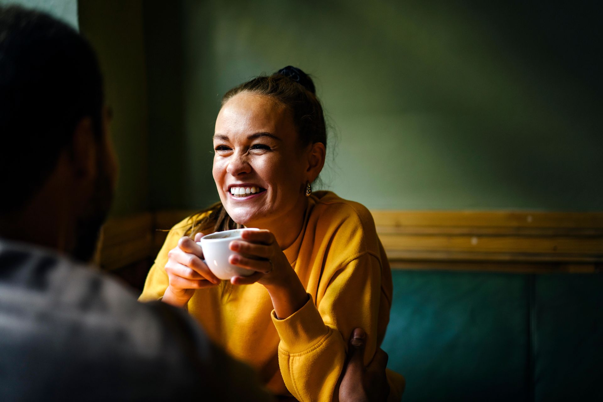 Woman in cafe holding coffee cup