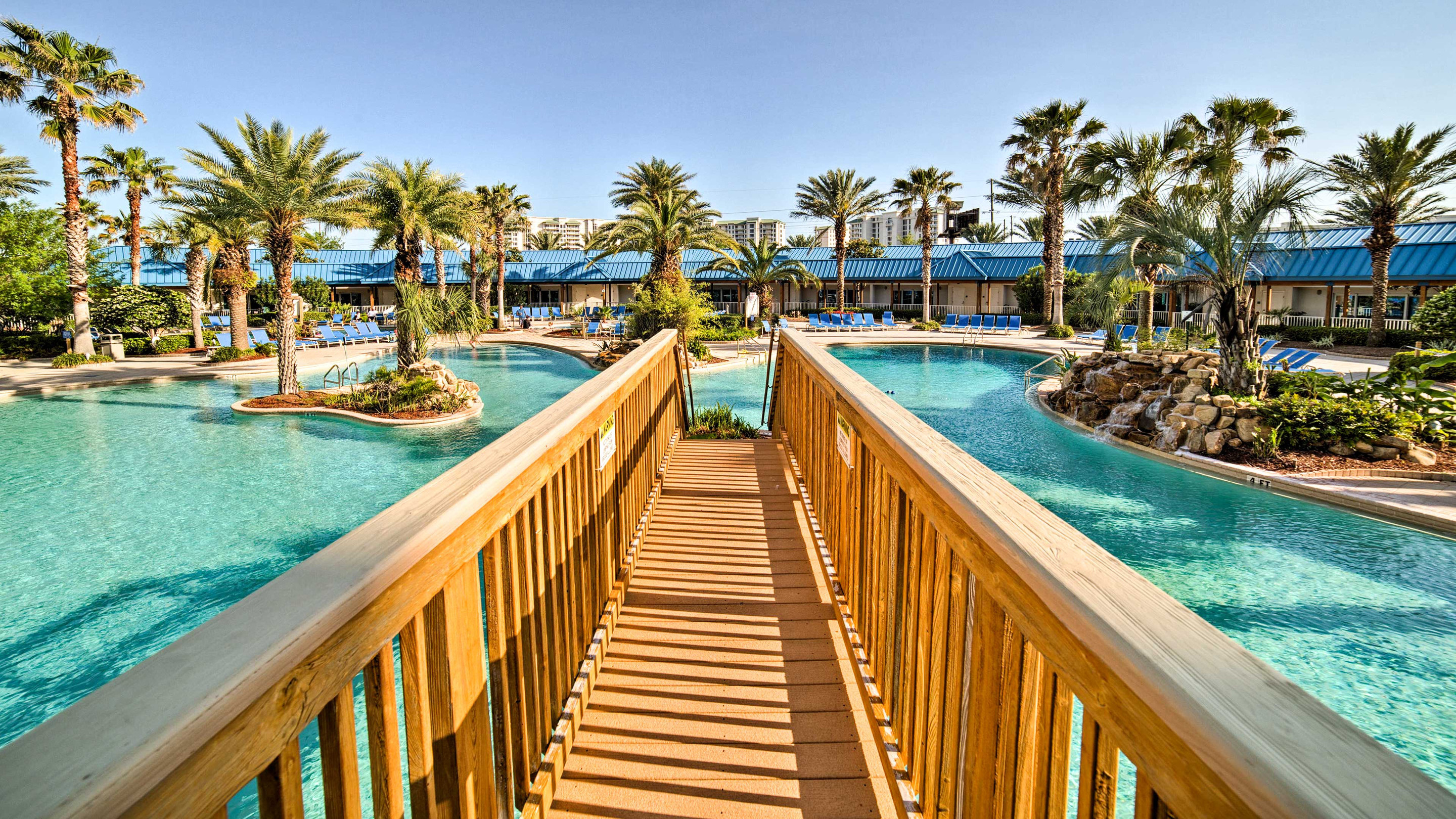 A Vacation Condo Rental In Destin With A Lagoon Pool And A Wooden Bridge 