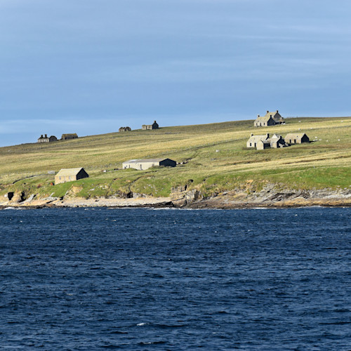 Scottish country cottages spill down a Scottish island near the sea