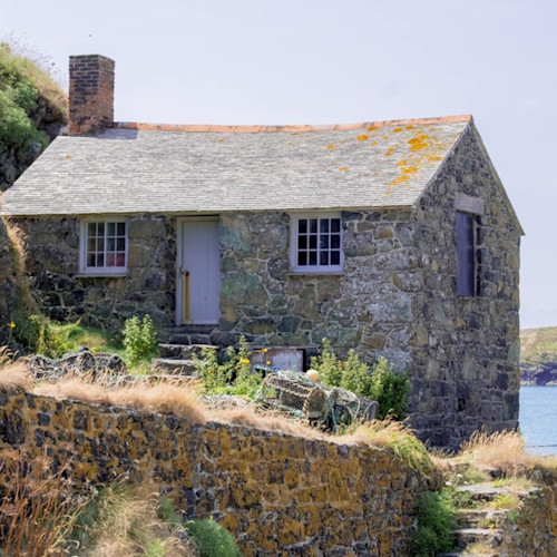 A unique cottage stands on a perch above the coast
