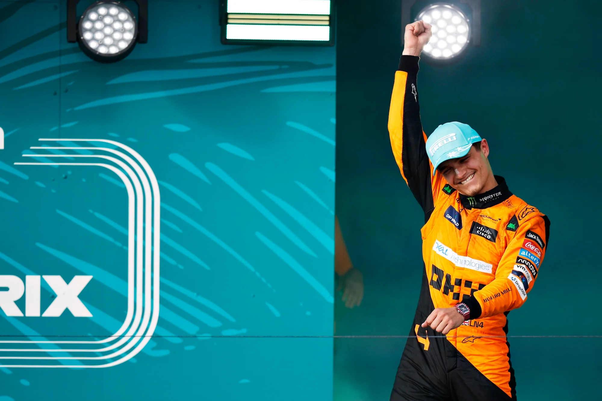 Race winner Lando Norris celebrates on the podium after the 2024 Miami grand prix