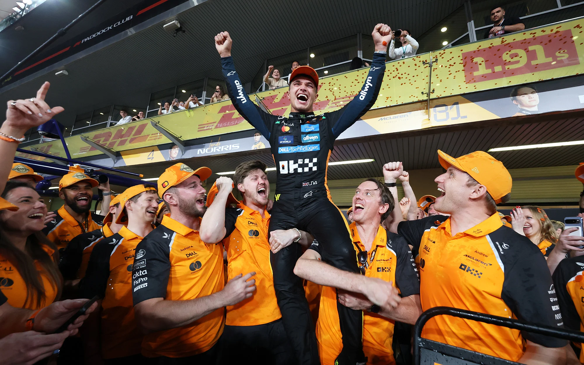 Lando Norris and the McLaren team celebrating after the title win in Abu Dhabi 2025