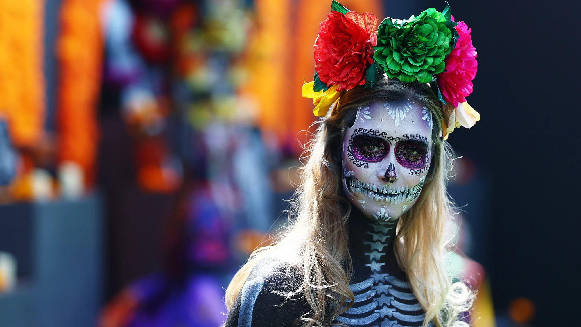 A woman in traditional dress and face paint looks on in the Paddock during previews ahead of the F1 Grand Prix of Mexico at Autodromo Hermanos Rodriguez on October 29, 2026 in Mexico City, Mexico.