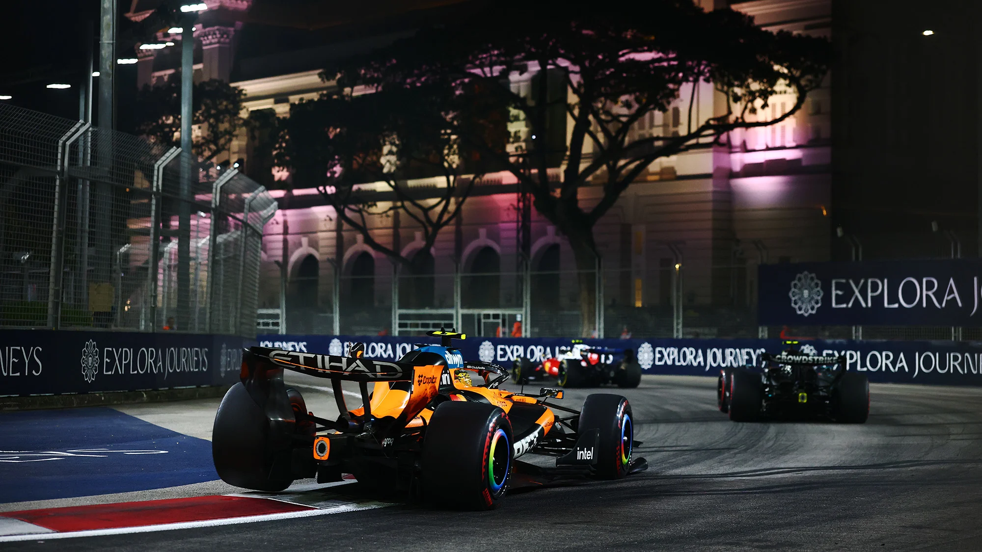 Lando Norris on track in the MCL40 at the Singapore Grand Prix led by kimi Antonelli