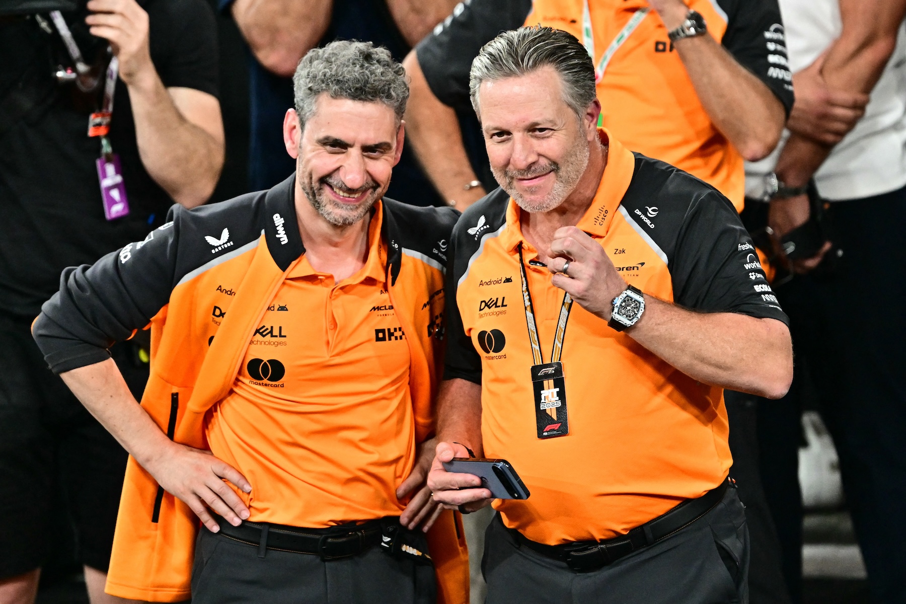 McLaren CEO Zak Brown and team principal Andrea Stella wearing papaya team uniforms in 2026