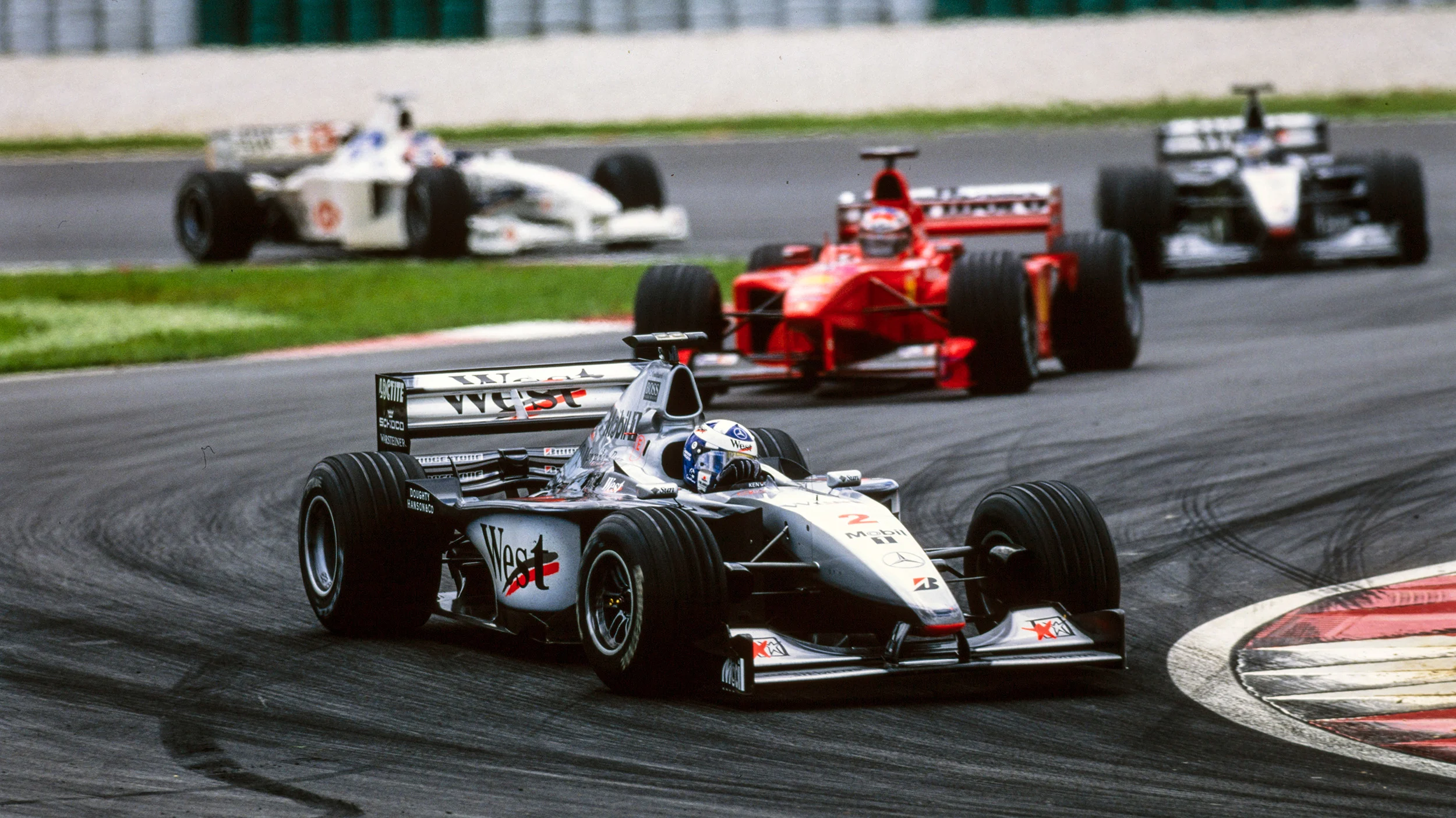 David Coulthard, MP4-14, leads Michael Schumacher, Mika Häkkinen and Rubens Barrichelloduring the Malaysian GP at Sepang International Circuit, 1999