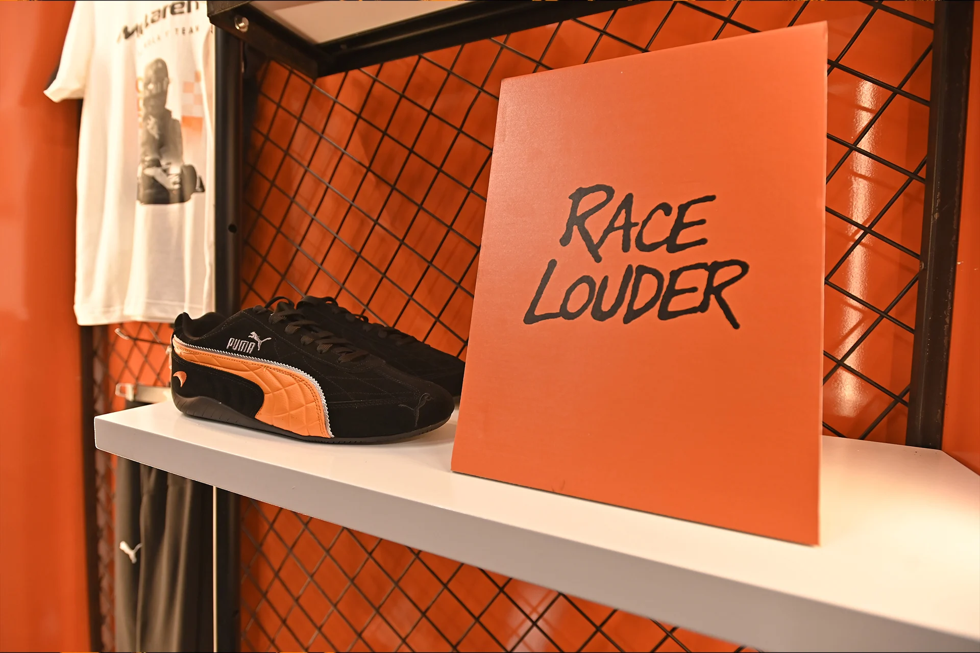 Puma shoes and a race louder poster