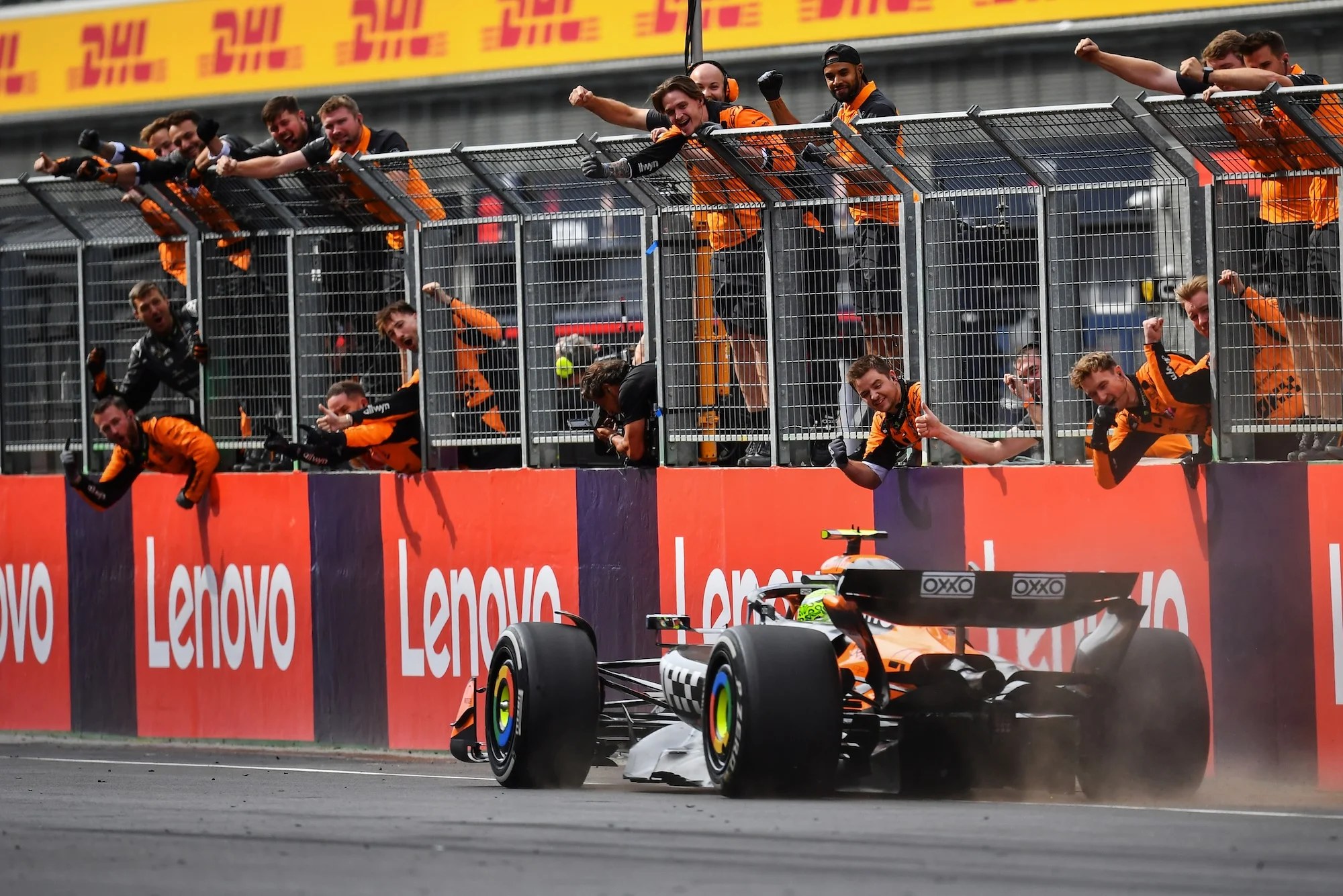 Lando Norris and McLaren celebrating at the pit wall after a grand prix win