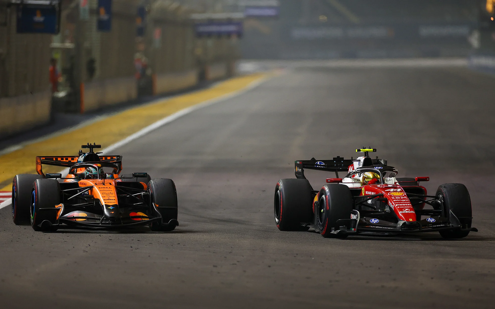 Oscar Piastri and Lewis Hamilton on track at the Singapore Grand Prix