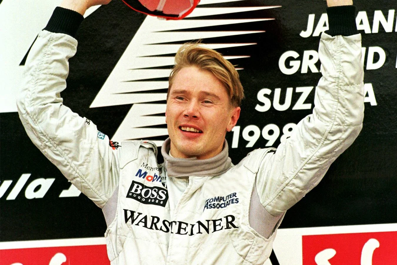 - 1998: Mika 'The Flying Finn' Häkkinen celebrates on the podium in Suzuka.