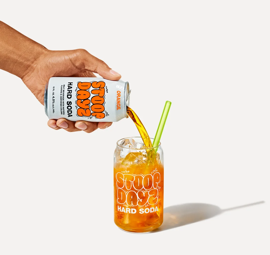 Orange Stoop Dayz Hard Soda being poured into a glass