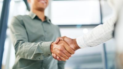 This picture shows two people shaking hands. It is meant to symbolize the beginning of a new business relationship.