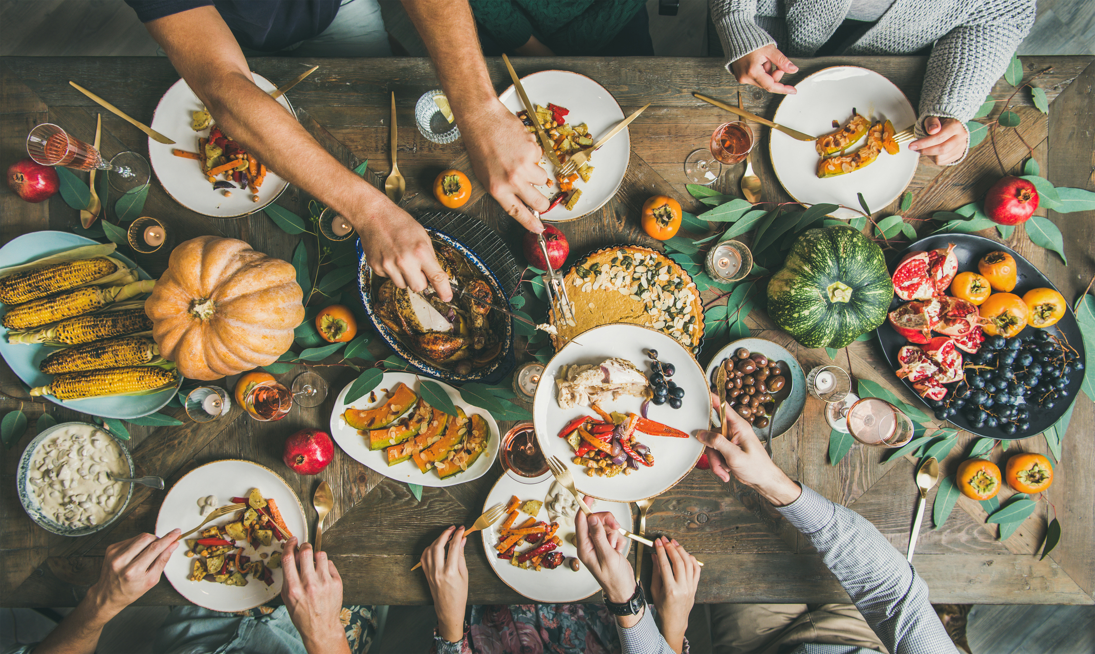 A group of people eating a vegan, plant-based Thanksgiving meal.