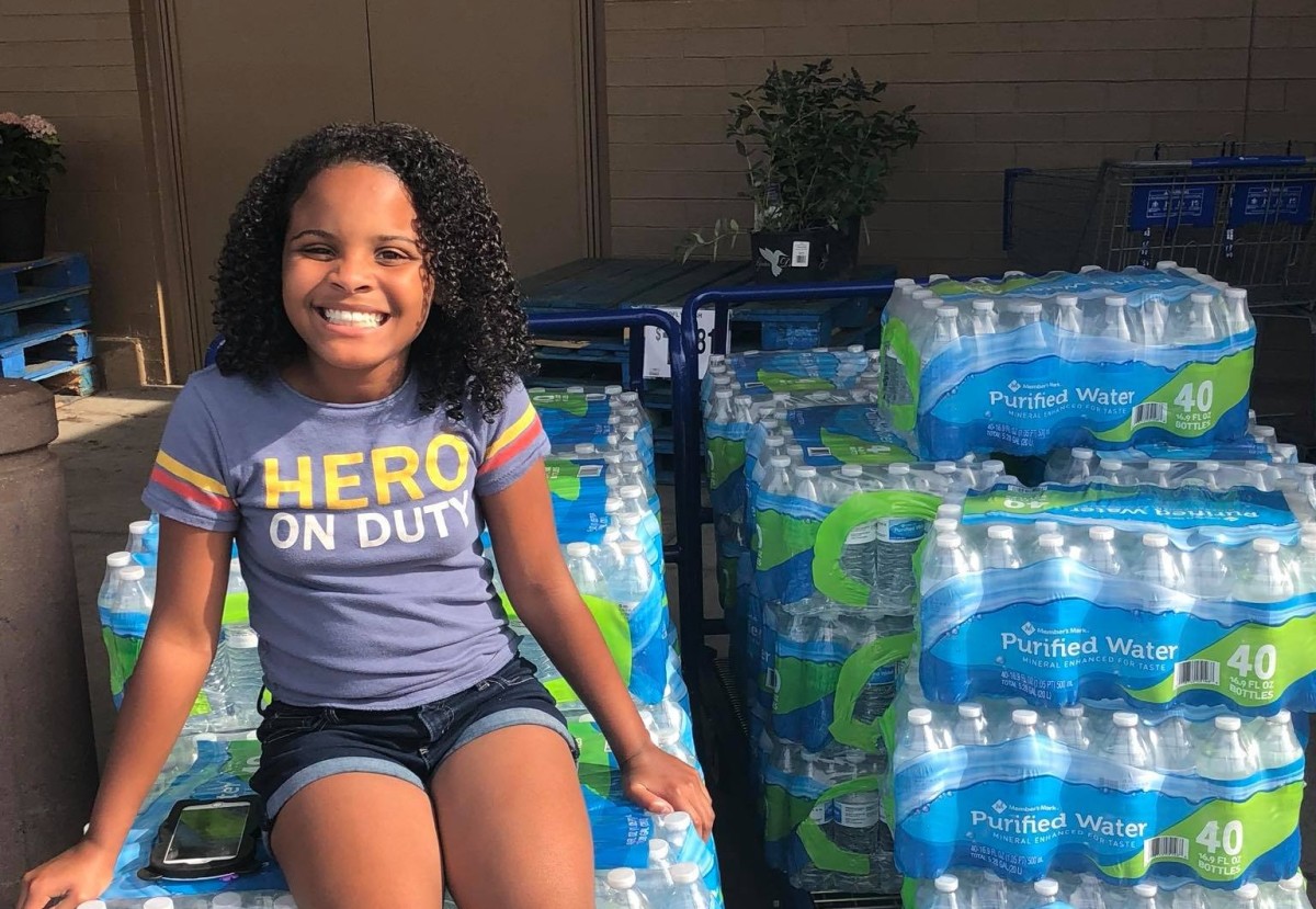 Mari Copeny with water bottles for Flint, Michigan