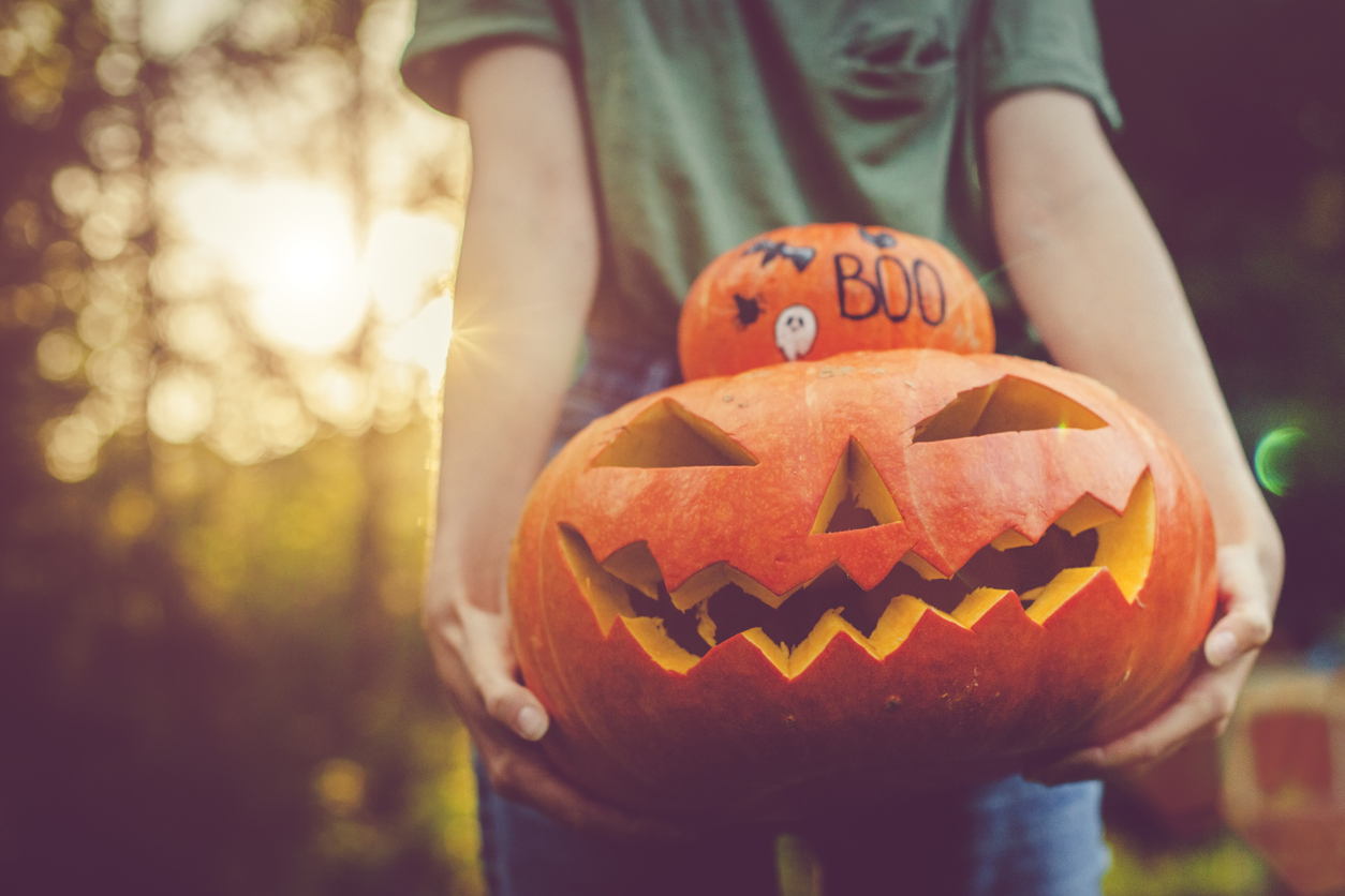 child holding jack-o-lantern