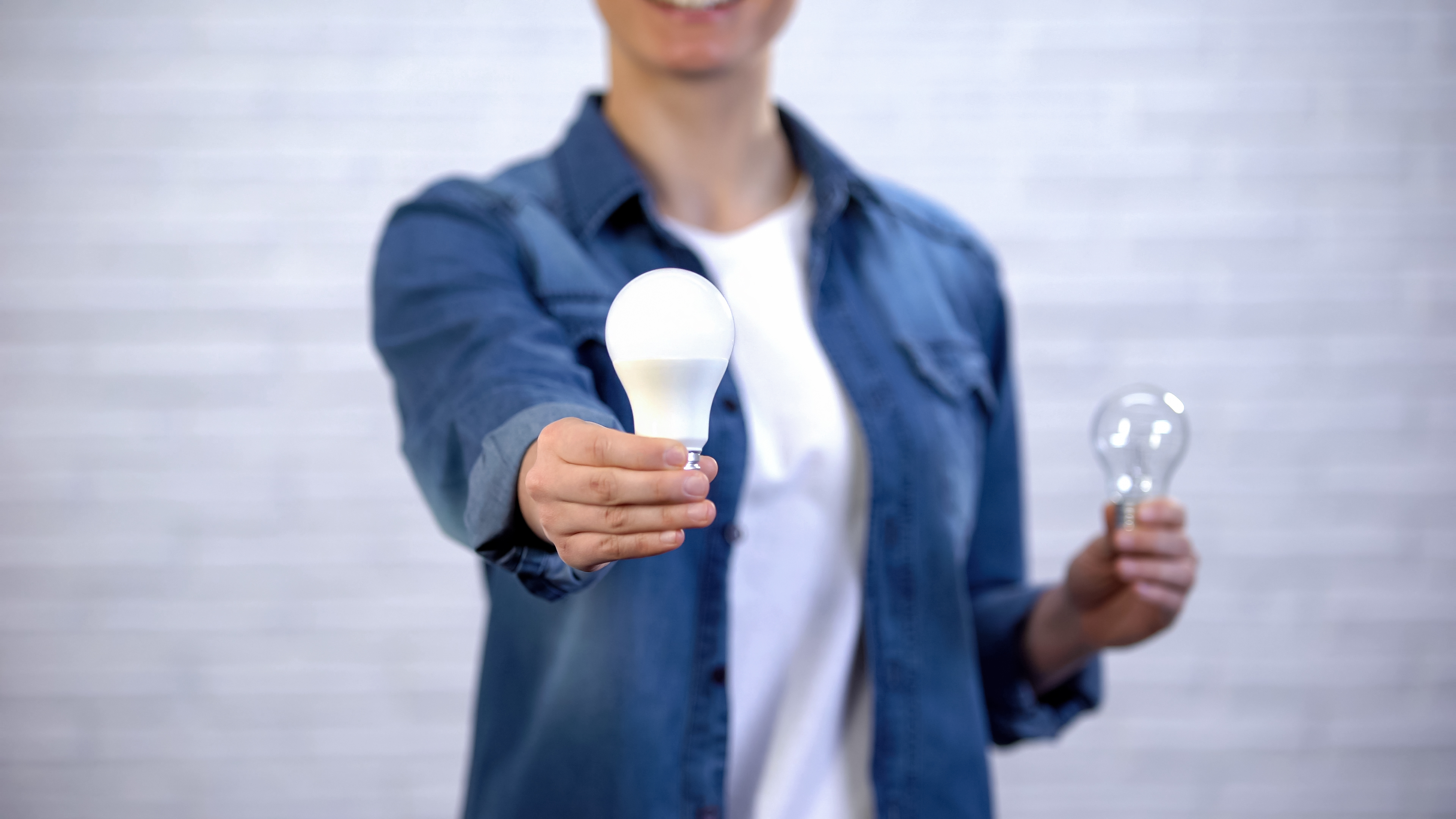 Woman holding an LED light bulb