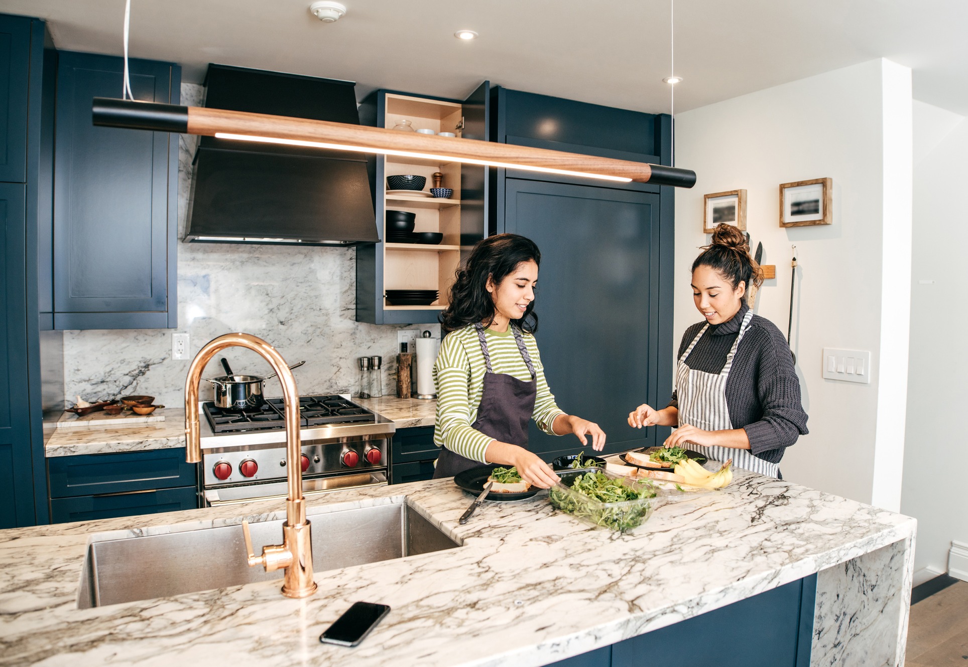 Two young women cooking a plant-based meal.