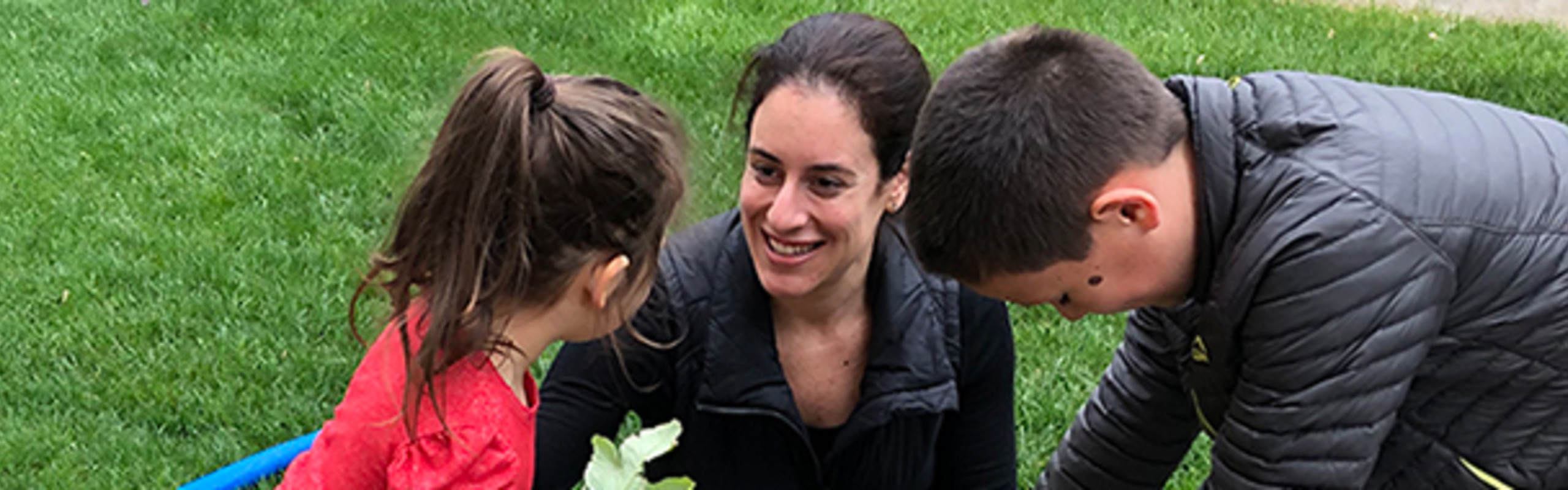 Laurie Cordova gardening with her children