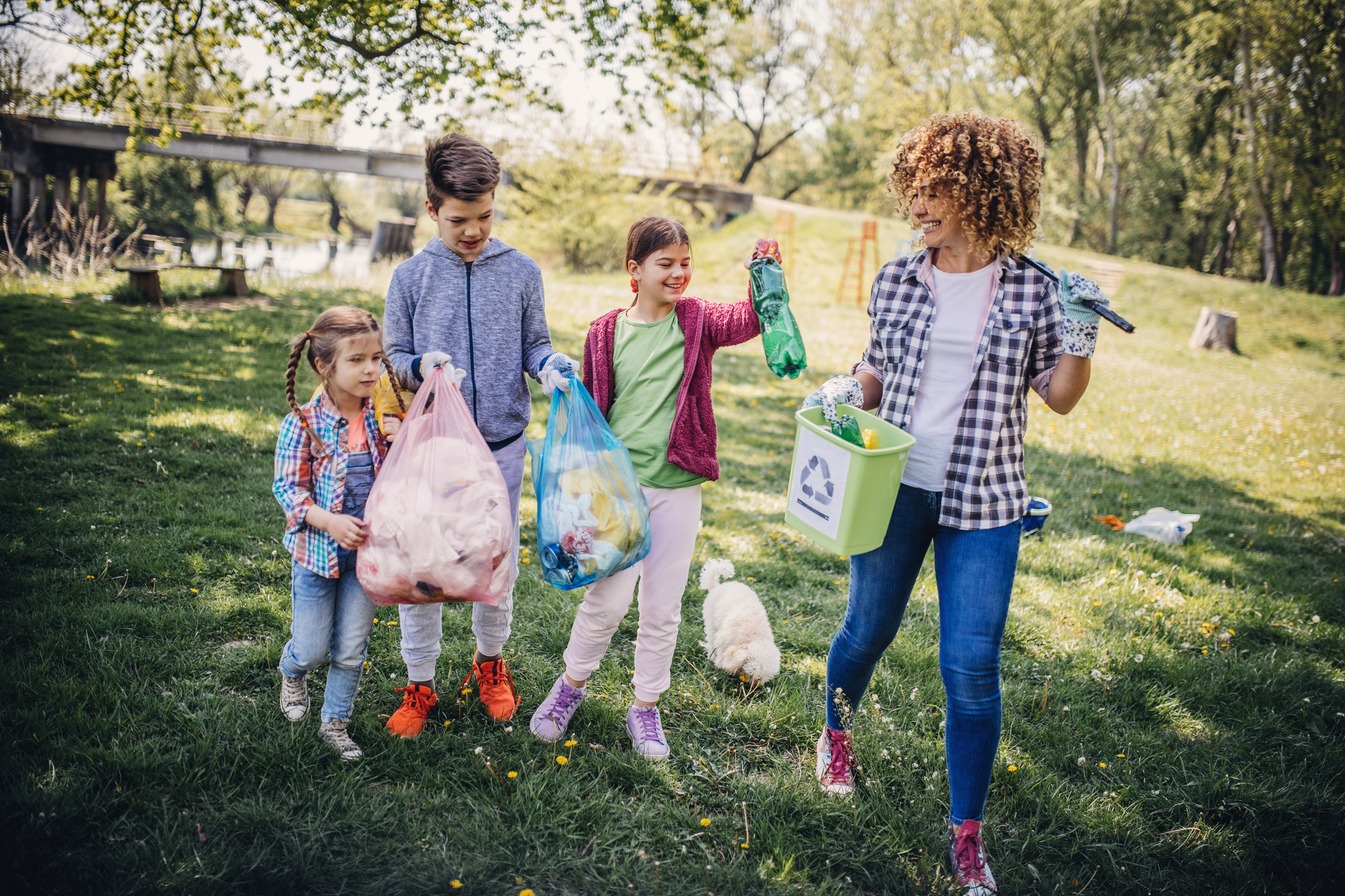 Kids picking up litter in a local park to help the environment and nature