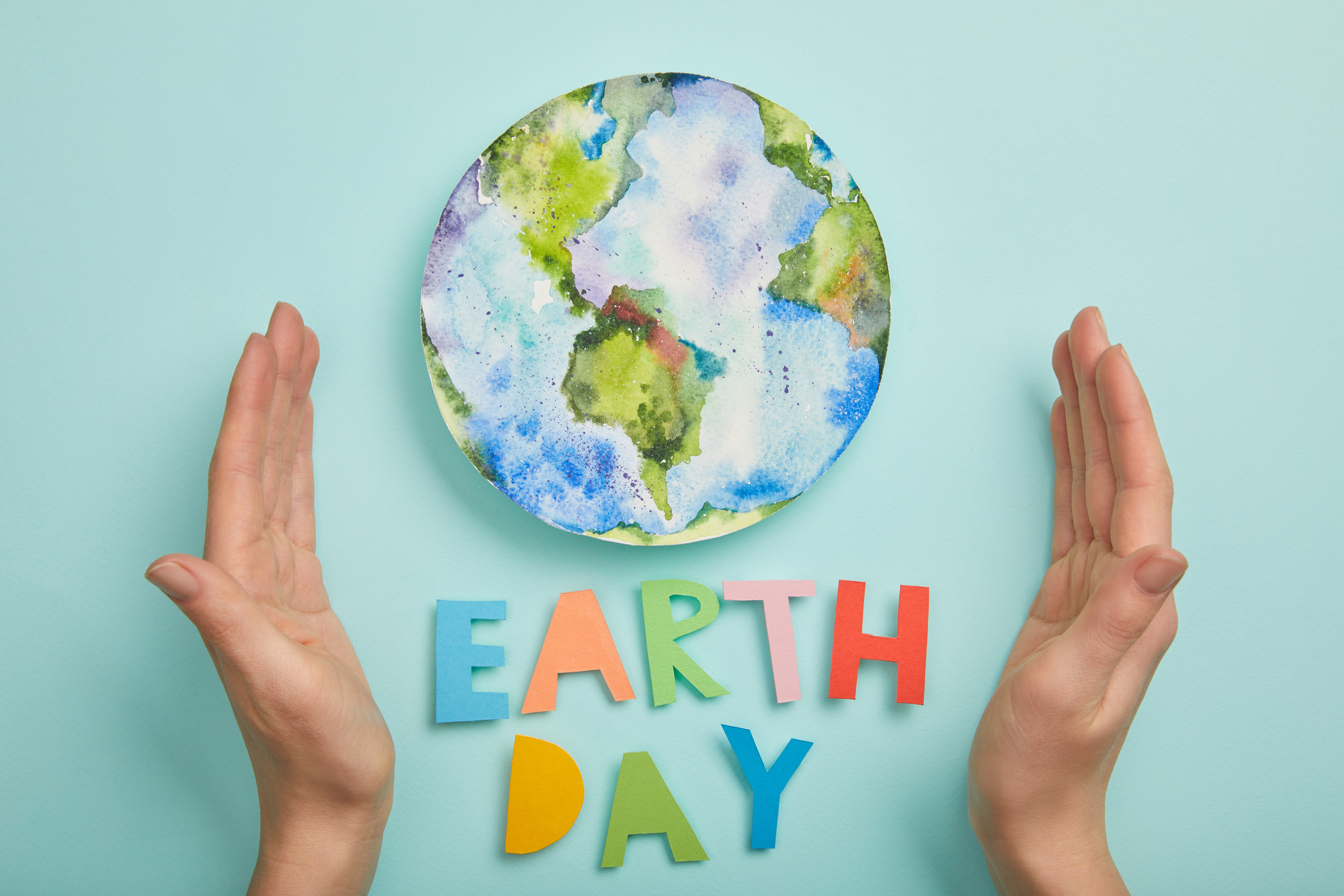 Earth Day globe and hands