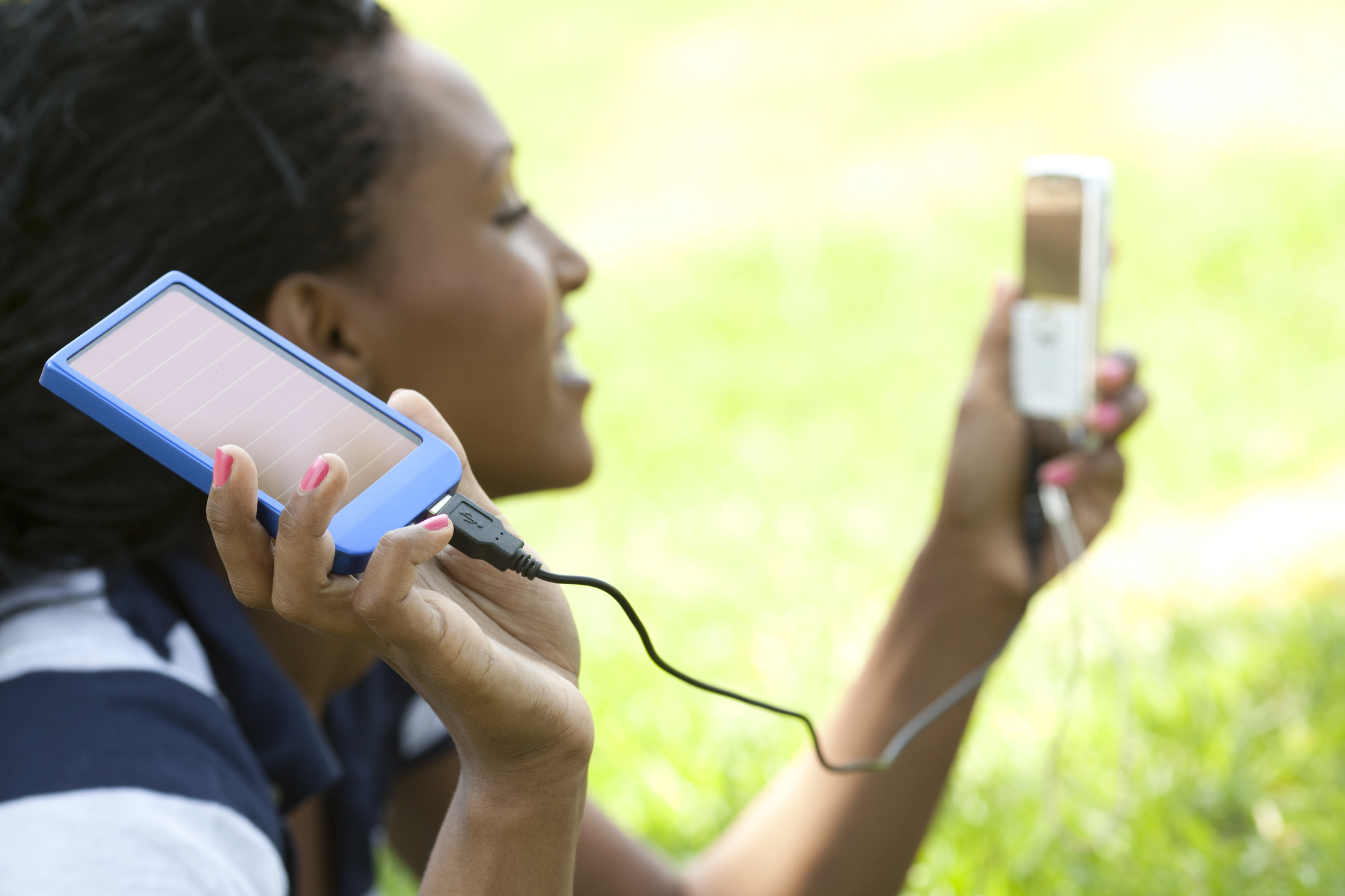 woman holding a solar phone charger