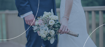 Cropped image of a bride and groom showing the woman holding flowers