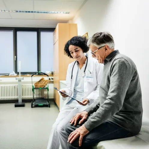 Doctor helping patient understand his chart