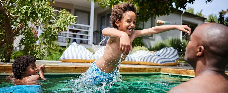 A joyful pool moment shared between parents and children.
