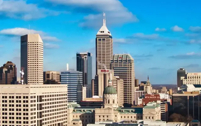 Picture of city skyline featuring multiple skyscrapers against bright blue sky