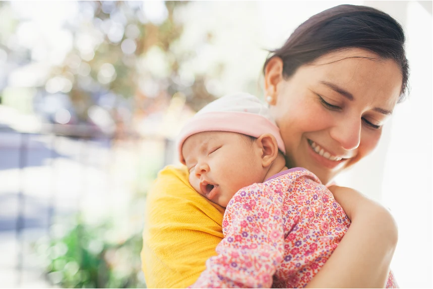 Mother holding newborn baby through IVF loans from OneMain Financial