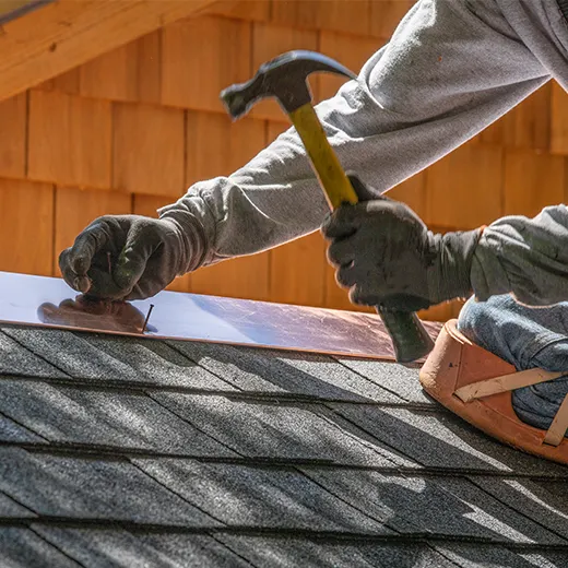 A construction worker is fixing the roof
