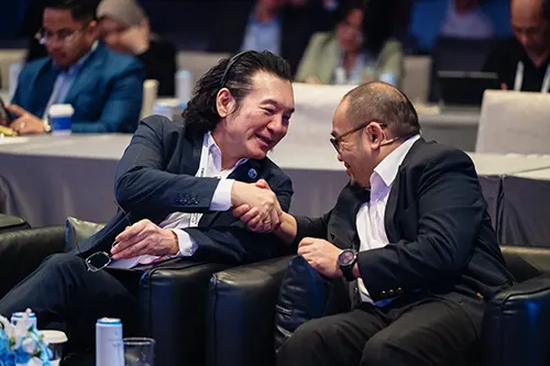 Delegates shaking hands at Money20/20 Asia in Bangkok