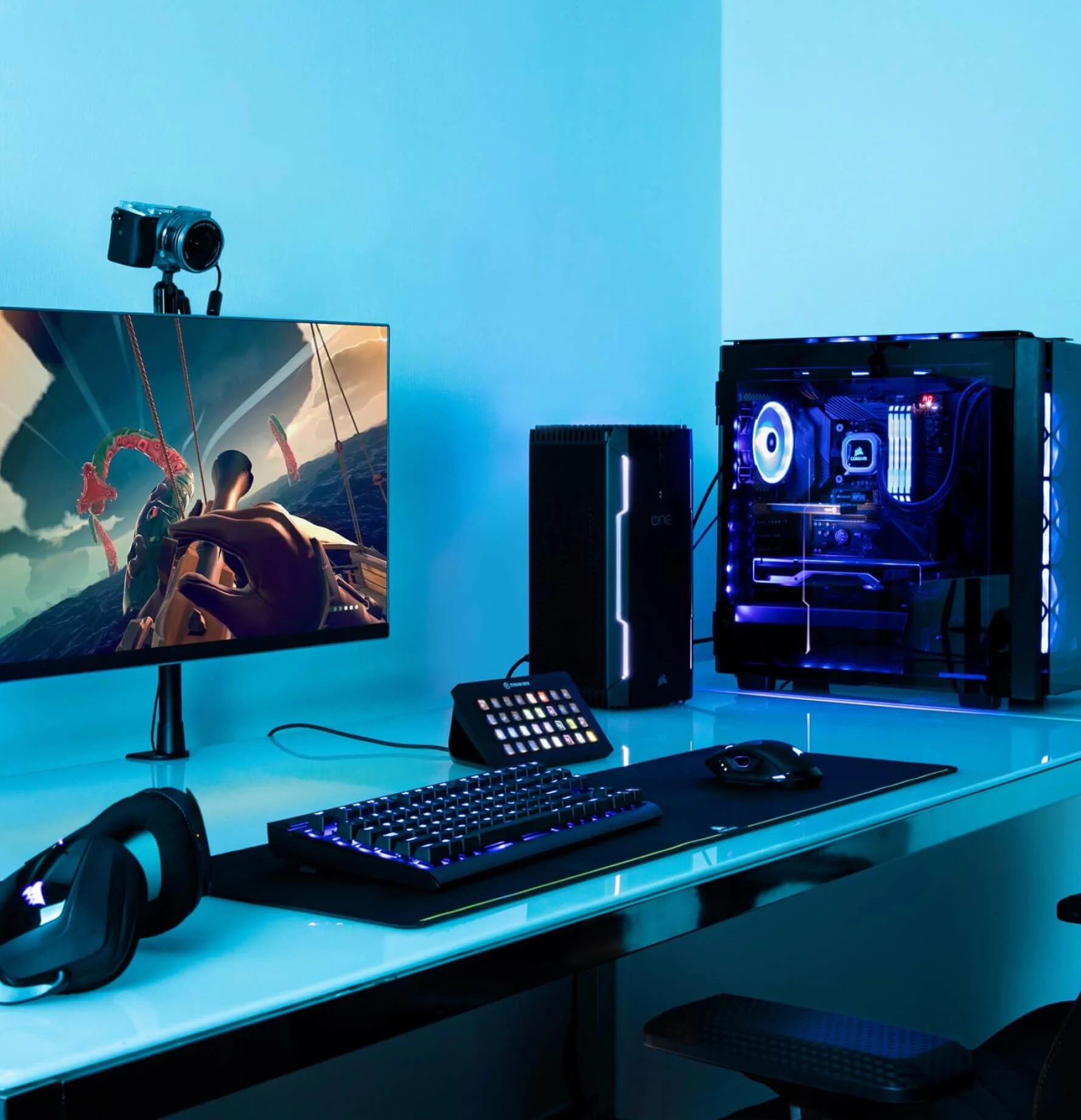 A streaming setup with a monitor and keyboard in the corner of the room with a mouse on it, featuring Stream Deck XL and 4K60 Pro in a PC Case
