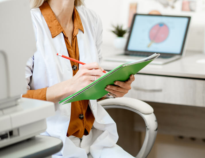 Eye doctor writing down test results