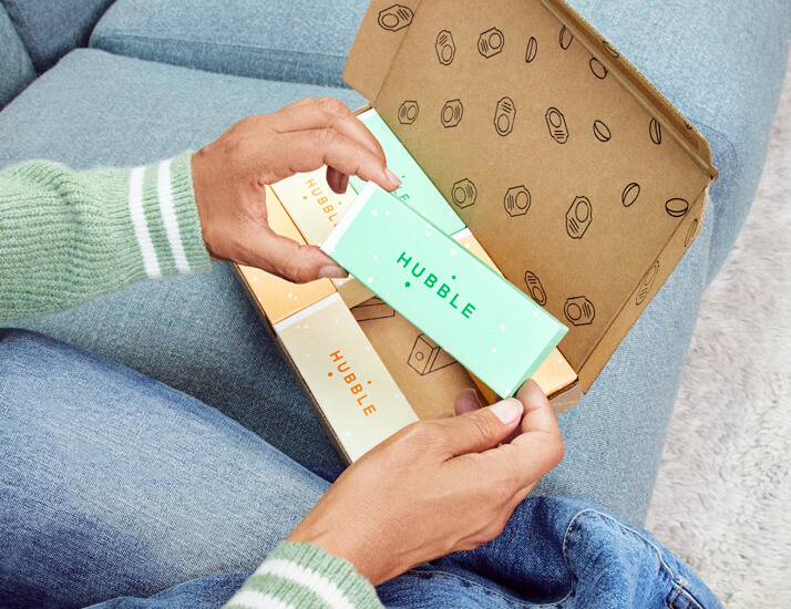 Man unboxing a new delivery of Hubble Contacts