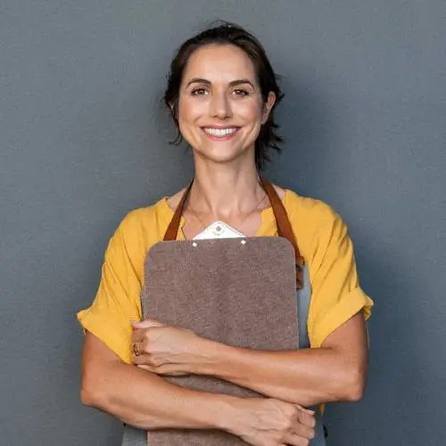 Woman smiling holding a folder