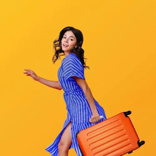 Lady with orange suitcase posing and smiling