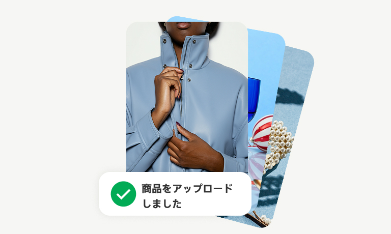 重なり合ったピン 3 件：一番上のピンは青いシャツのボタンを留めている人の画像。「商品のアップロードが完了」というテキストが重なっている。   