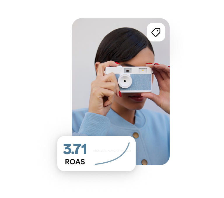 A person is holding a blue camera the words “3.71 ROAS” appear overlaid in the corner. 