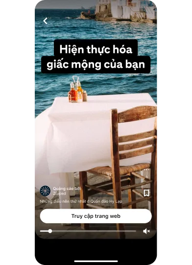 Hình thu nhỏ xem trước quảng cáo ý tưởng cho thấy bàn ăn với tầm nhìn ra mặt nước có tiêu đề "Thực hiện ước mơ của bạn" với nút "Ghé thăm địa điểm" nằm ở chính giữa phía dưới cùng.