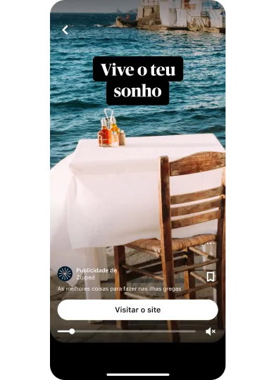 Miniatura da pré-visualização de um anúncio de ideia que mostra uma imagem de uma mesa de jantar com vista para o mar, com o título "Live your dream" (que significa Vive o teu sonho), com um botão para visitar o site centrado na parte inferior.