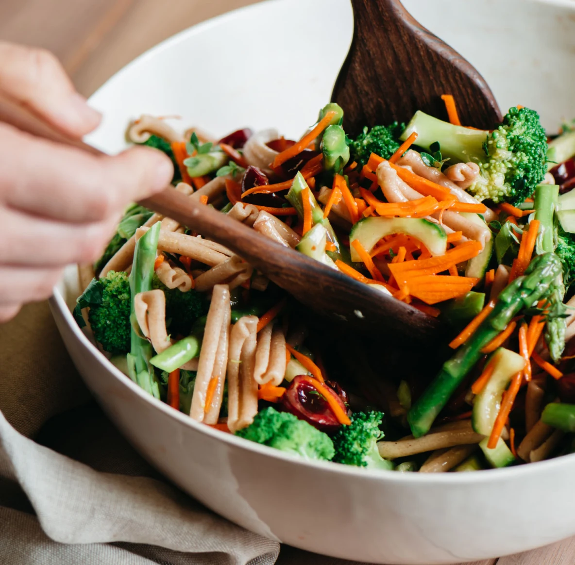 Wooden spoons mixing a salad