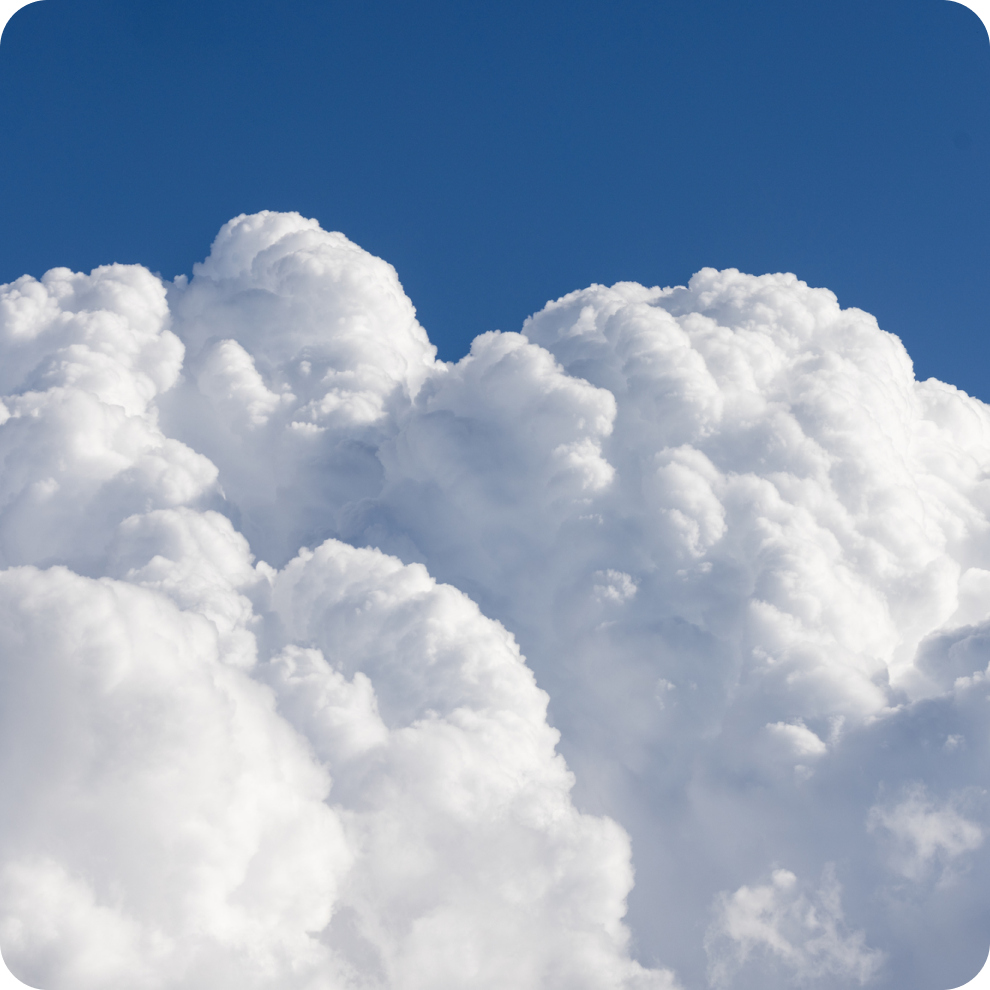 A photo of fluffy white clouds in the sky. 