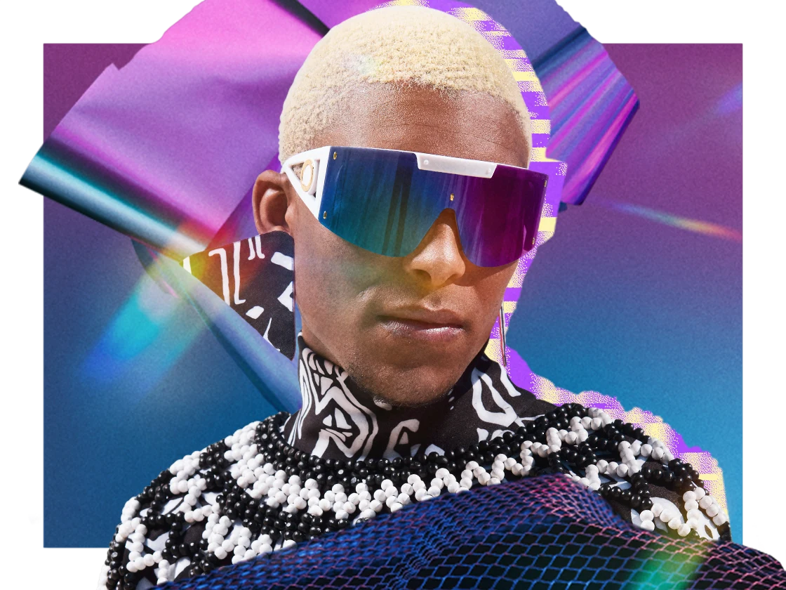 A Black man is wearing big, reflective sunglasses and dystopian-inspired clothing.